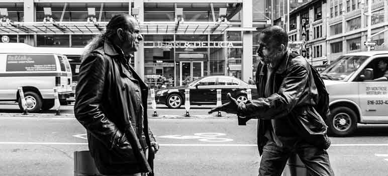 Two men stop to have a conversation on the street. Image Credit: Jim Pennucci, via Flickr/CC.